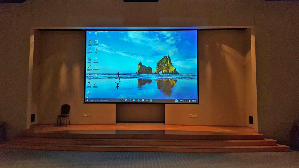 Desktop projected onto a projector screen in a meeting space